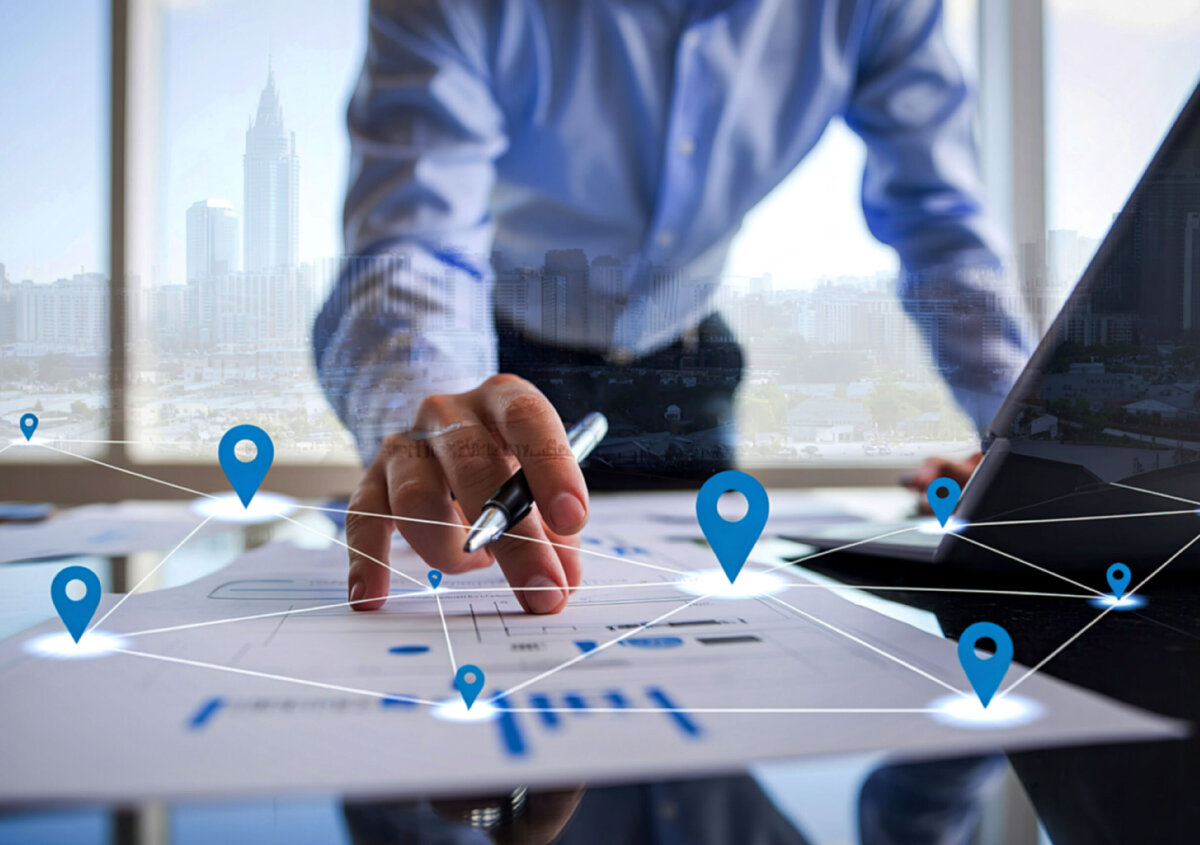 Business professional reviewing documents with location markers and network connections, illustrating location-aware document automation in SmartDocuments FOUR.